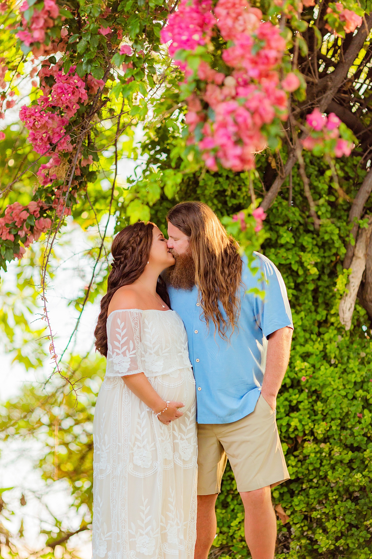 Beautiful Maui beach maternity session with bougainvillea in foreground