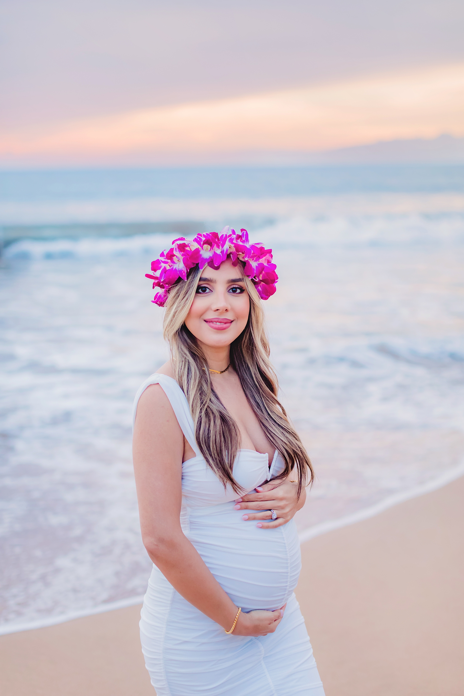 pregnant woman wearing purple lei po'o on maui during her babymoon photoshoot