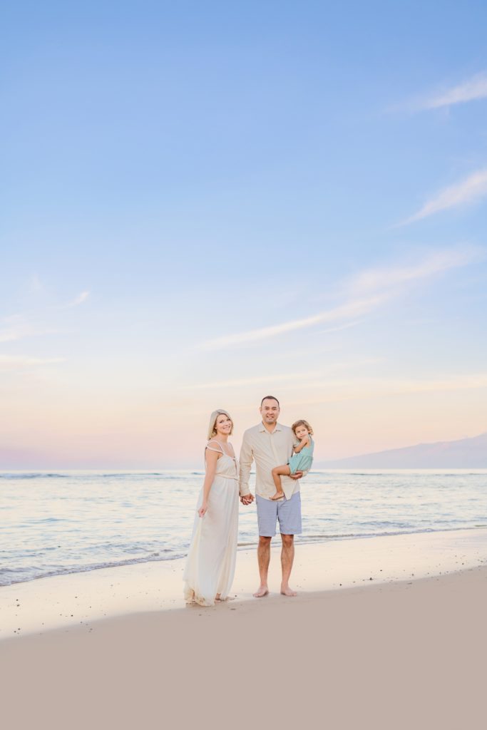 cute family of three photographed at sunrise in lahaina by love and water in maui