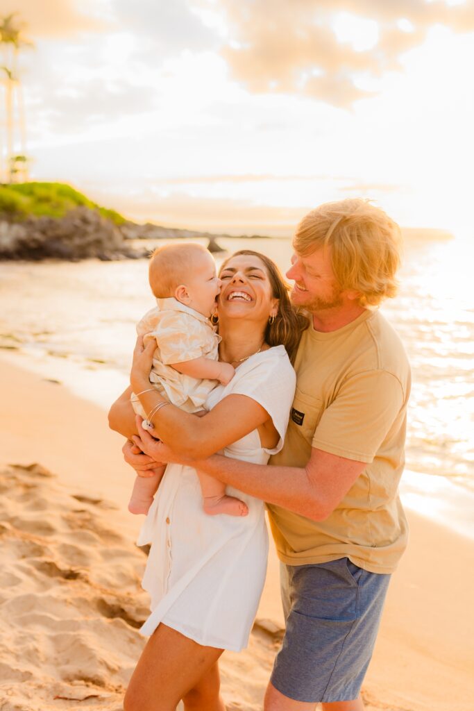 Infant kisses mother on cheek in Kapalua at Love and Water Maui family photoshoot