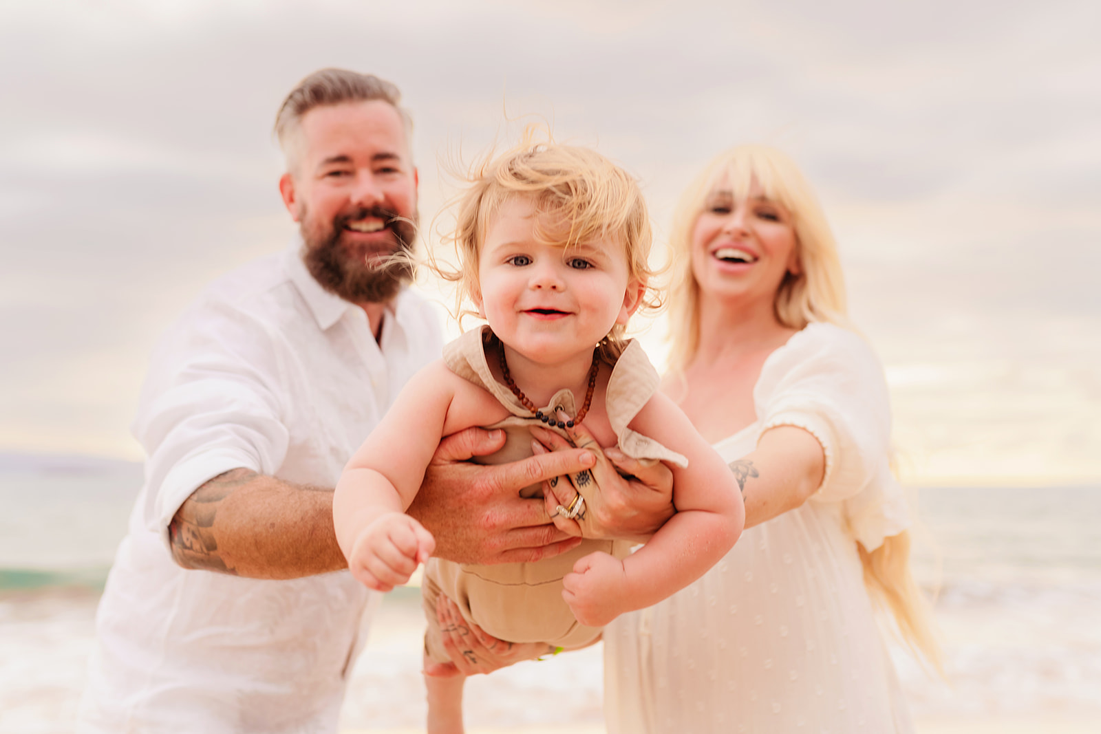 An adorable photoshoot with a toddler, his father, and pregnant mother for a family maternity photoshoot on Maui.