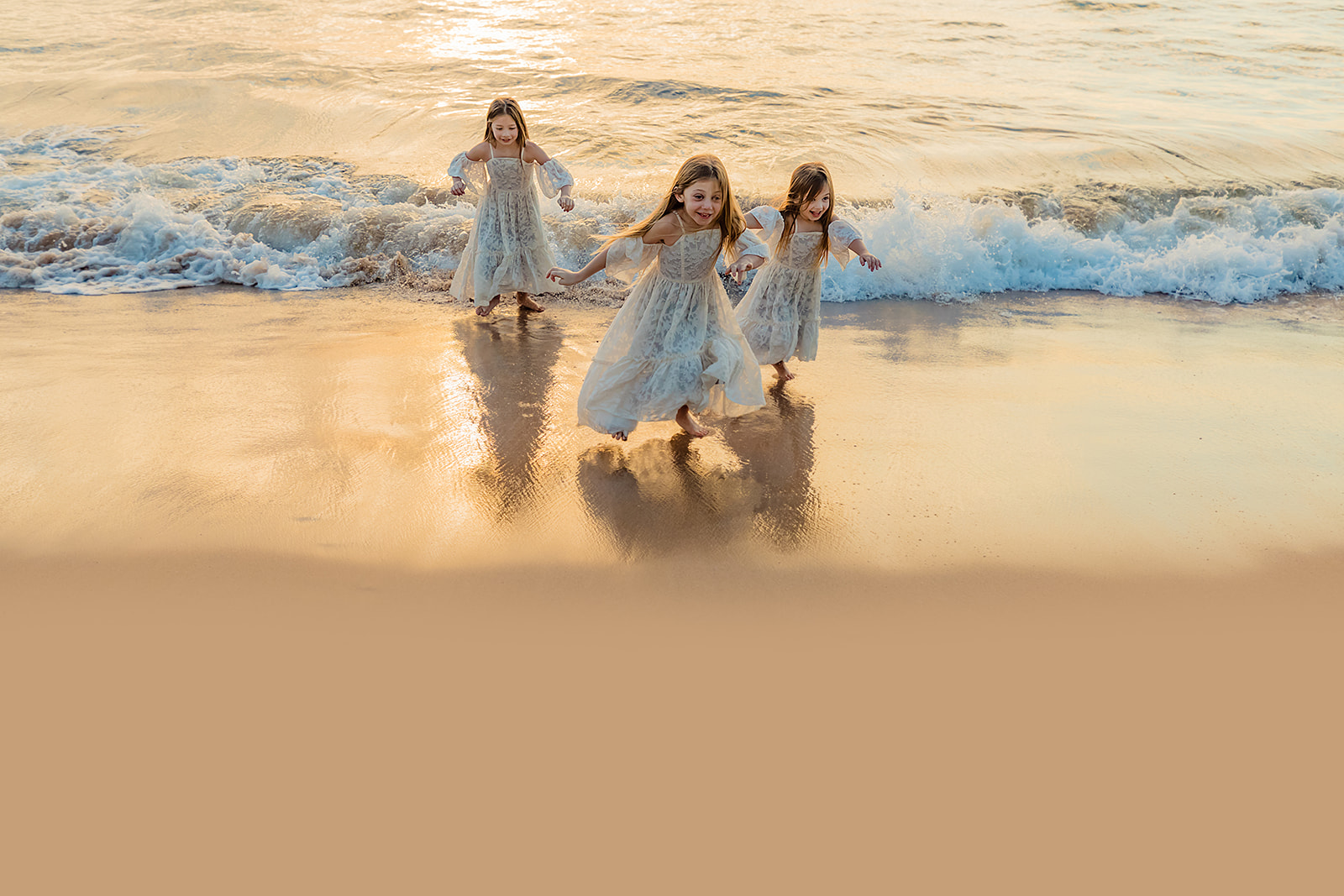 mother daughter photoshoot with little girls playing in maui hawaii water at the beach