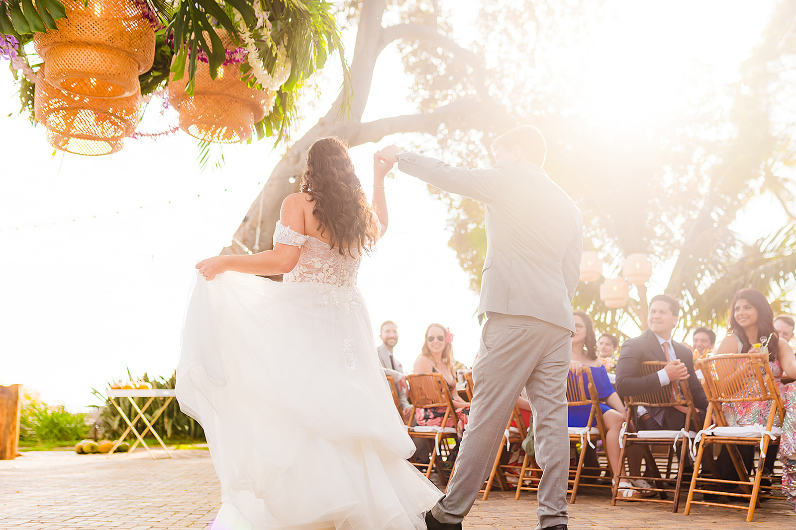 A bride and groom enjoy their first dance at an outdoor maui wedding near the ocean at Olowalu Plantation House.