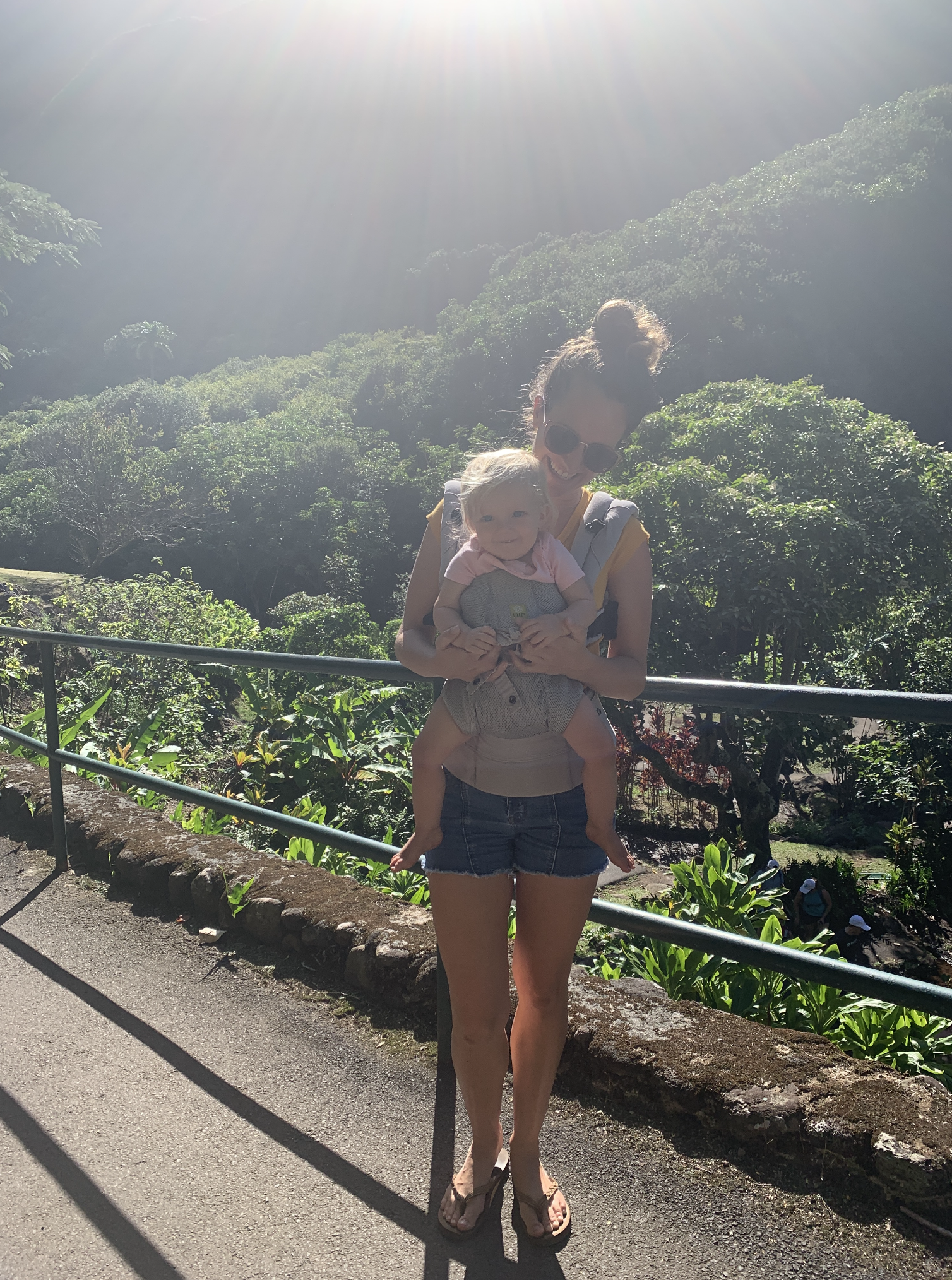 Mom carries baby in front carry using LÍLLÉbaby complete airflow carrier while exploring Iao Valley on Maui