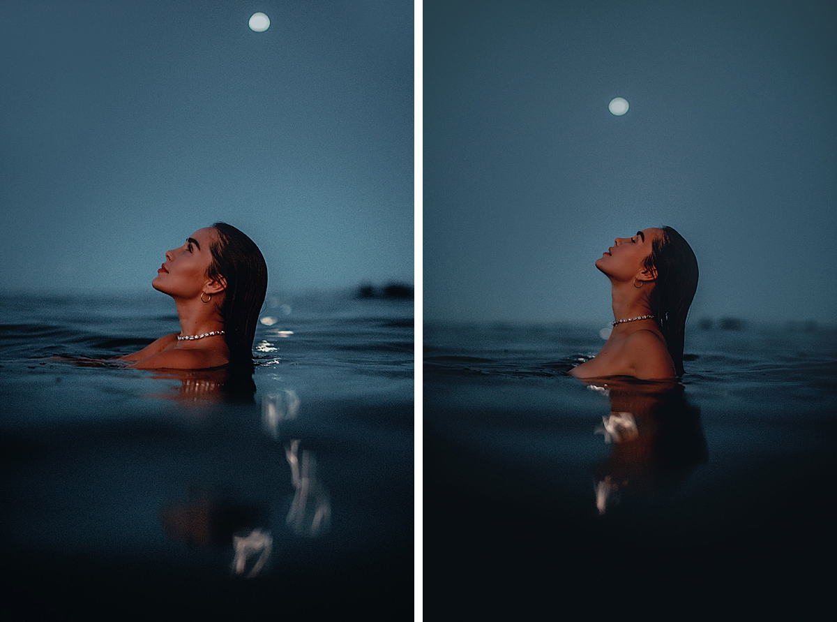 woman neck deep in the ocean as the full moon rises in the background