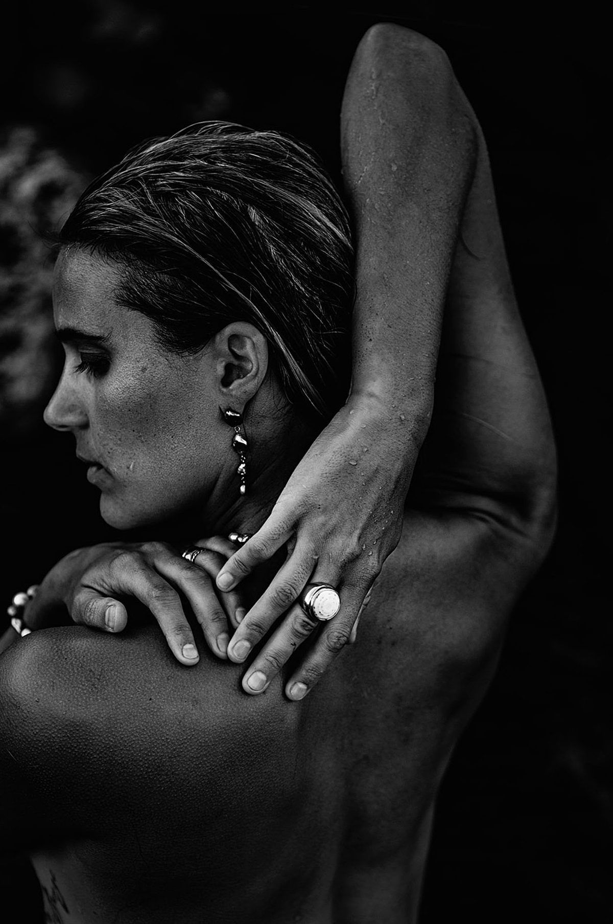 woman on maui posing with puka perri jewelry for a powerful black and white portrait