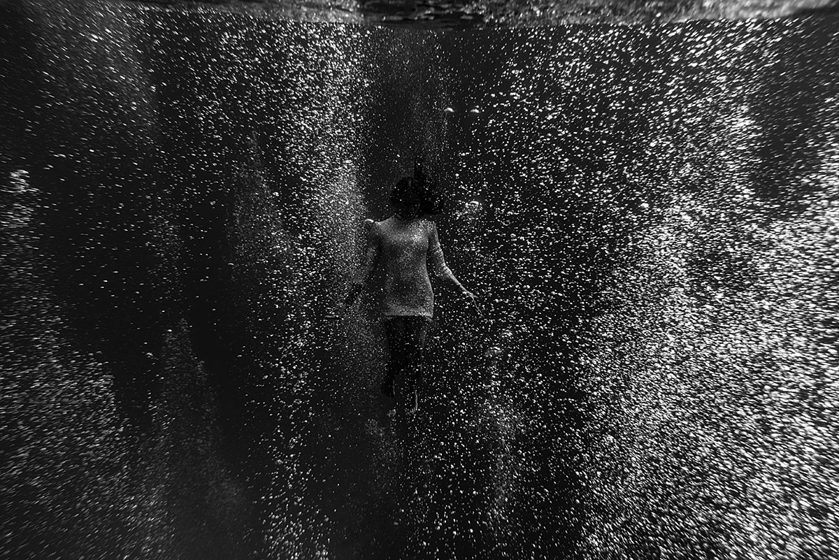 bubbles surround a woman in the ocean for underwater portrait photographed by love and water