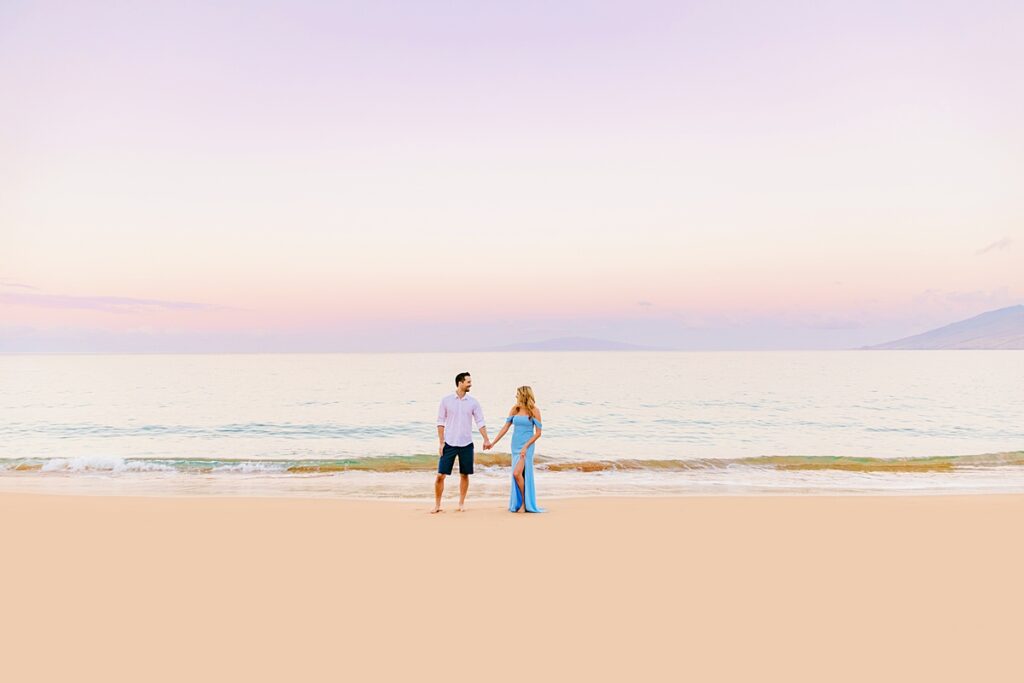 Maui honeymoon portraits for a couple wearing blue and white under a sunrise sky in Wailea, Maui