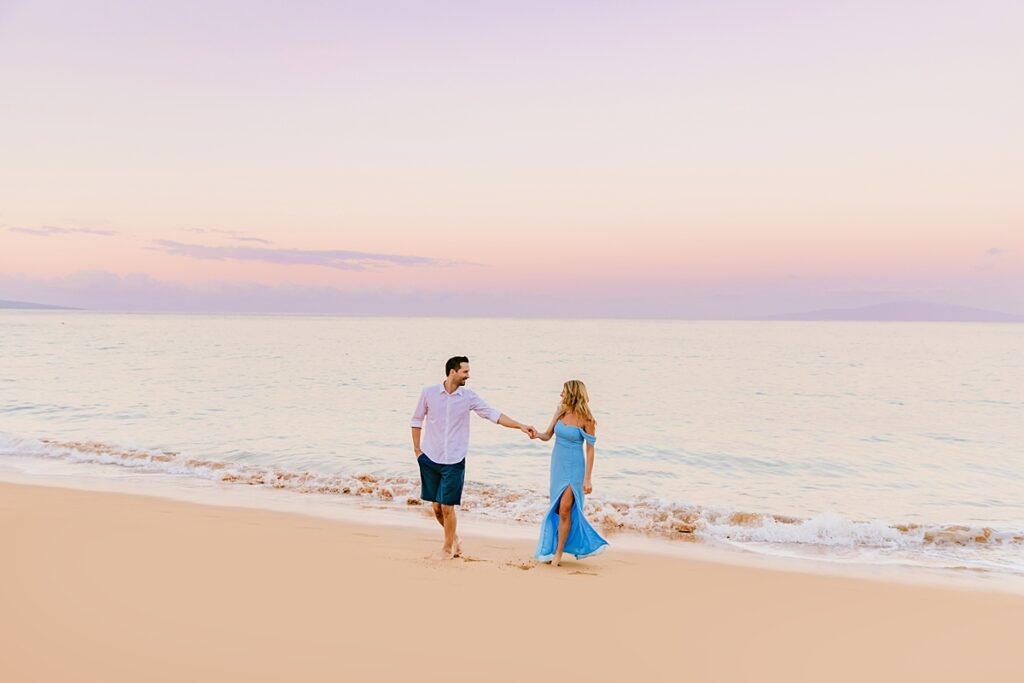 Pastel skies surround a couple during their Maui engagement shoot photographed by love and water