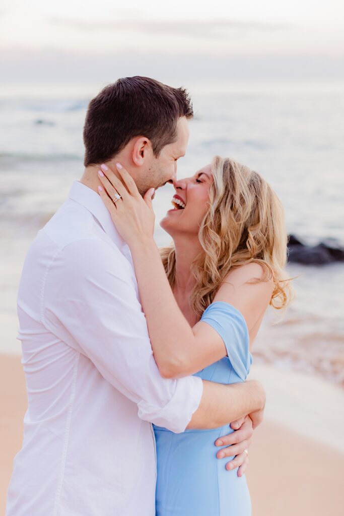 woman laughs with her husband at the beach in hawaii