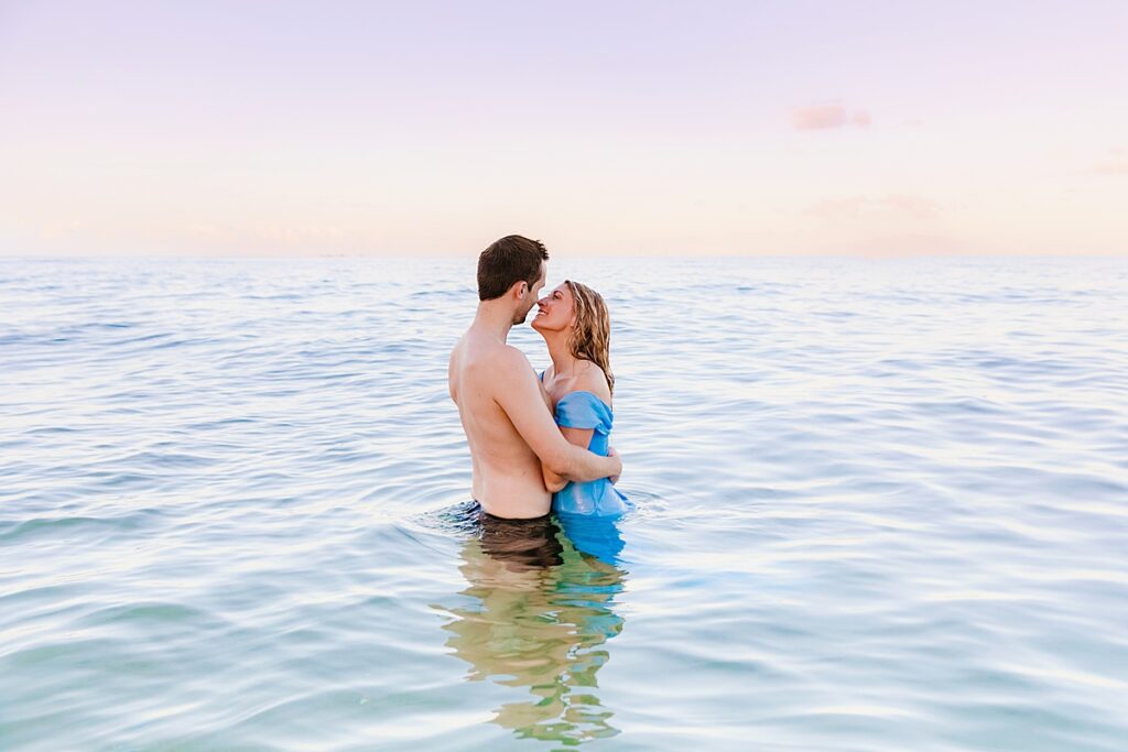 maui photographers love and water capture a tender moment between newlyweds celebrating their honeymoon on maui