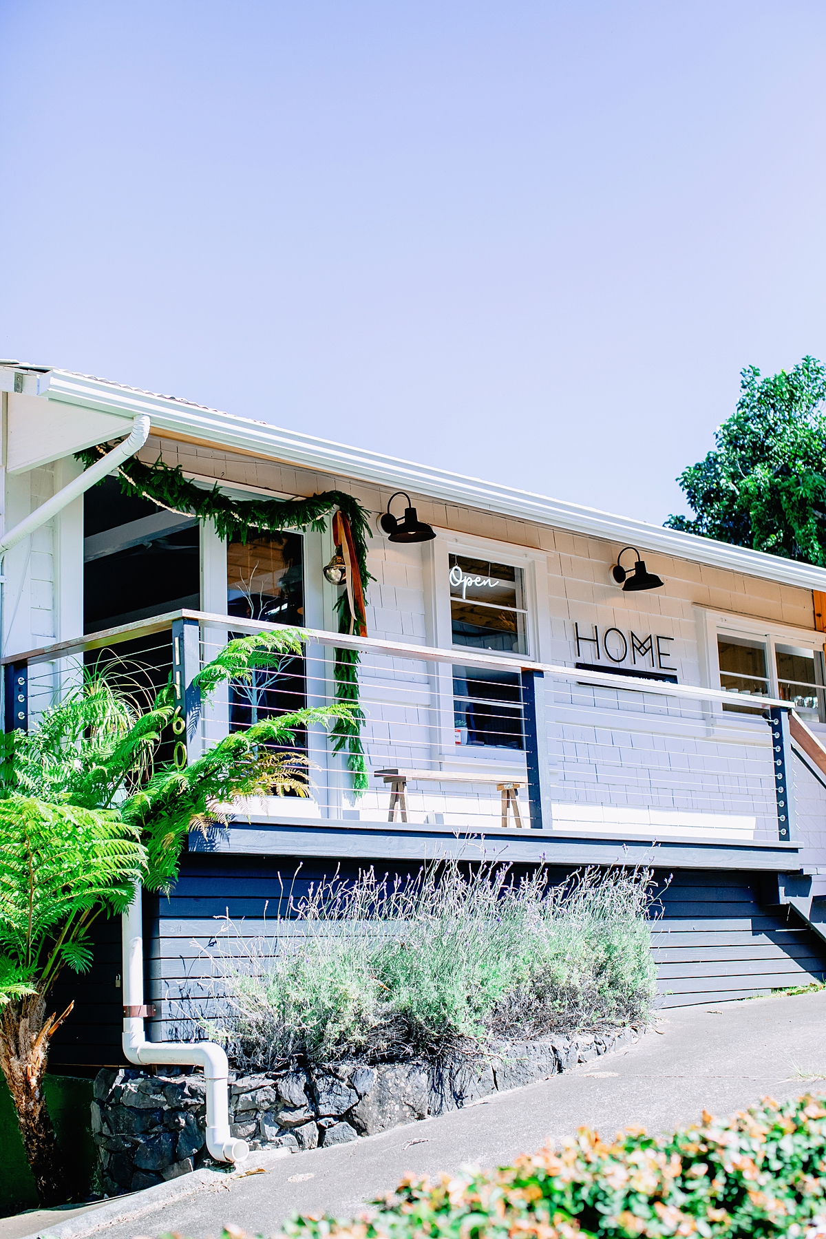 home by driftwood exterior with white wood panels and modern branding