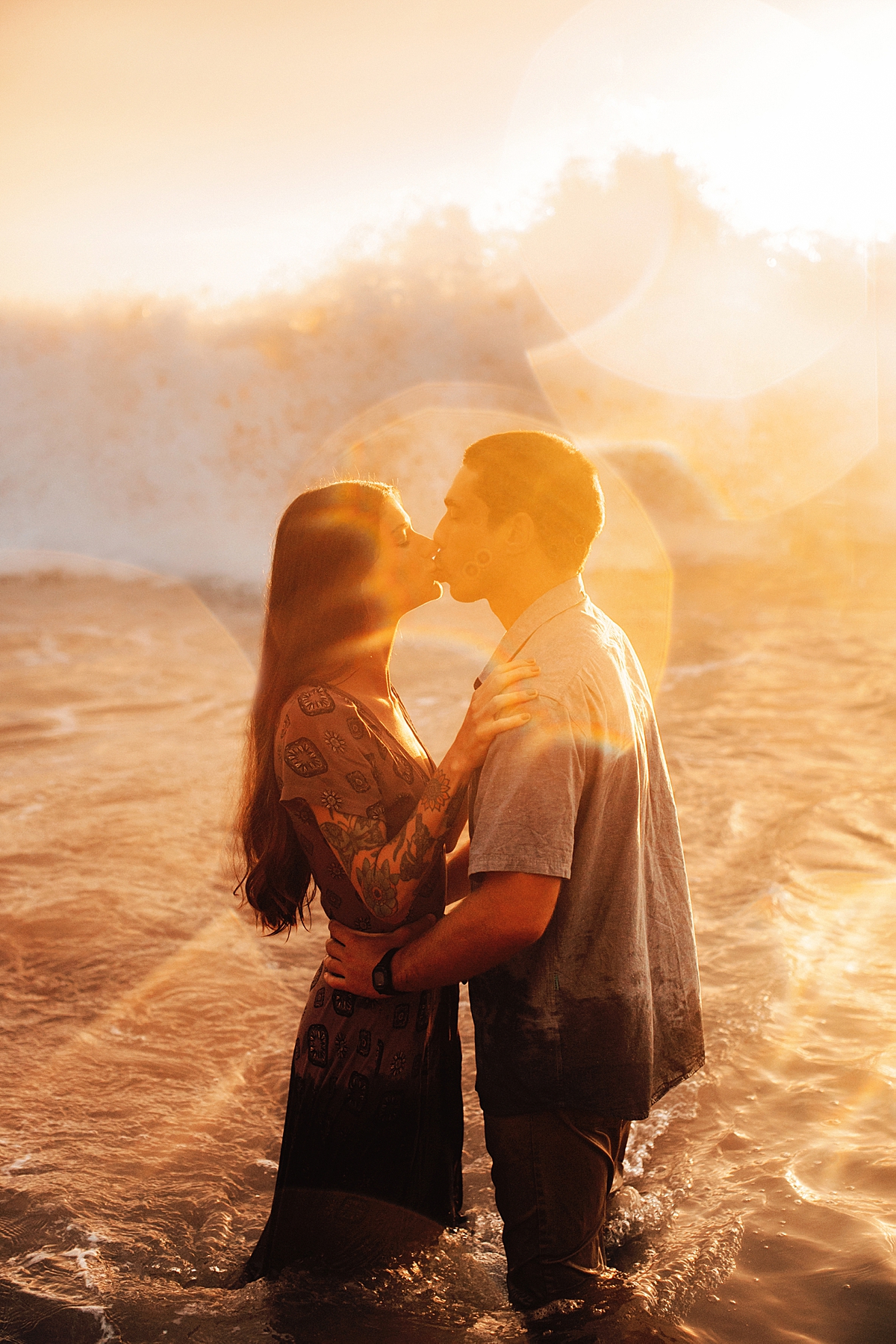 Couple kissing in the ocean during a Maui photoshoot with Love and Water Photography after a rainy day