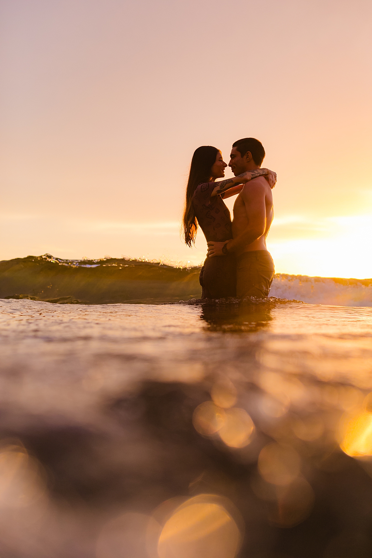 woman and man staring at one another in a romantic water portrait by love and water photography