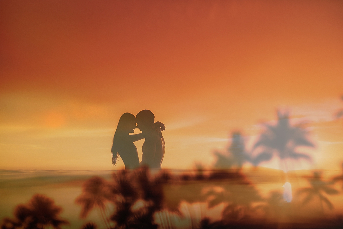 double exposure of couple embracing in the ocean for their engagement portraits on Maui