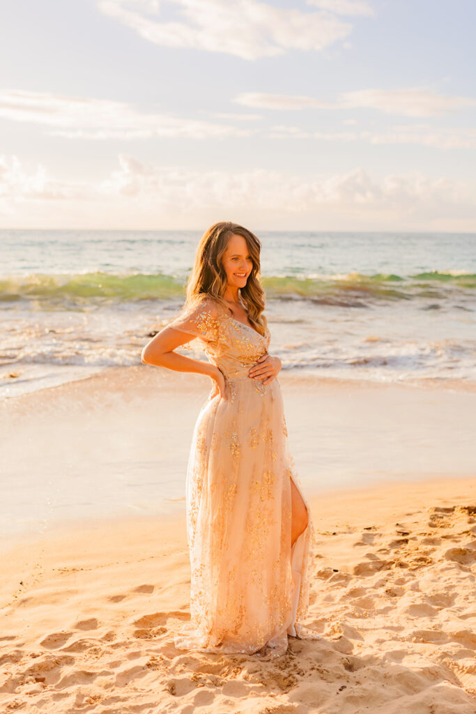 Pregnant 40 year old woman wearing Baltic Born maternity gown for Wailea beach babymoon portraits