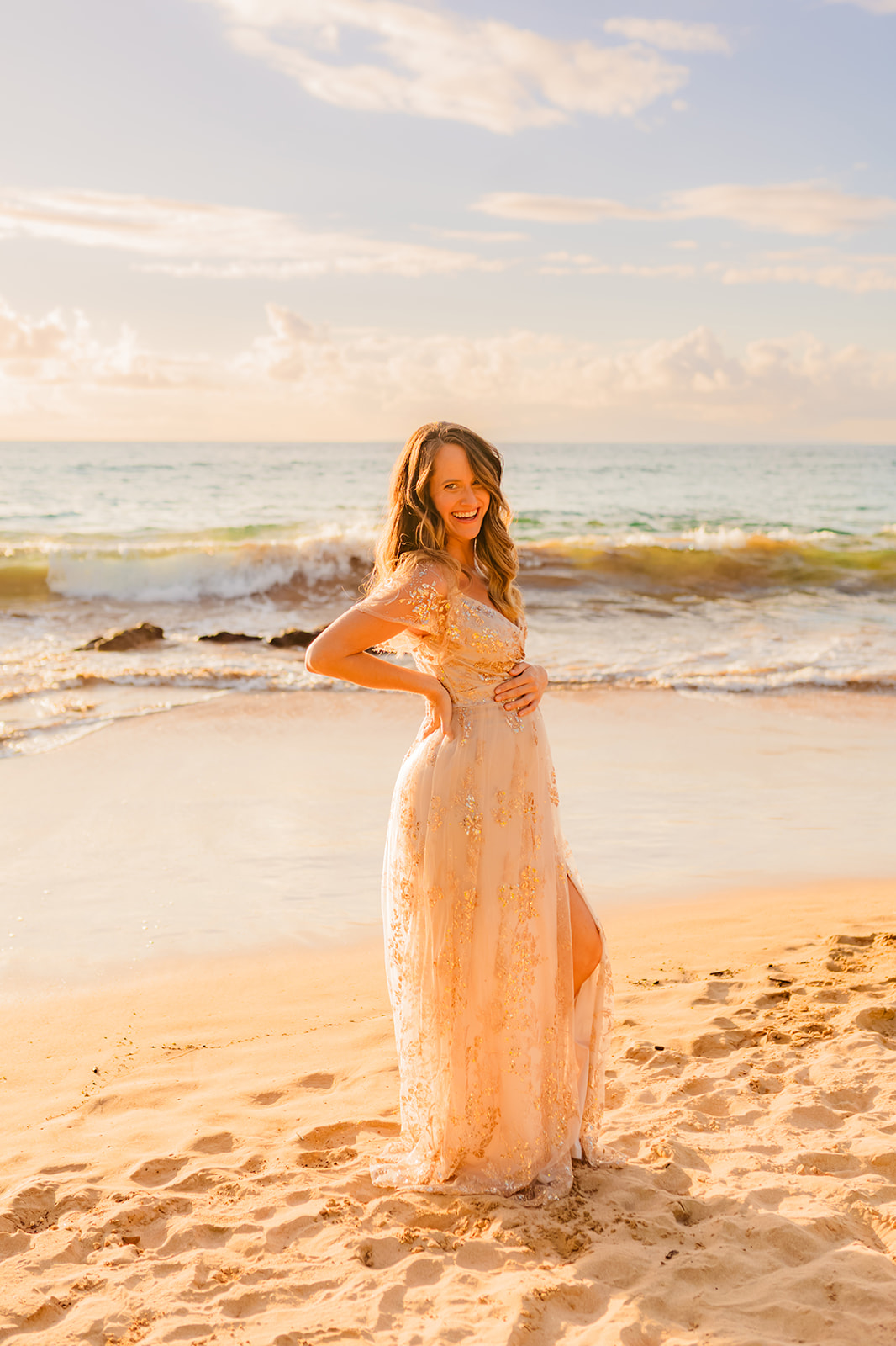 Woman 24 weeks pregnant smiling at camera wearing a sparkly maternity gown by baltic born