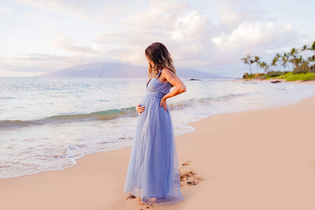 pregnant woman on Maui has babymoon portraits taken by love and water while wearing a baltic born maxi dress