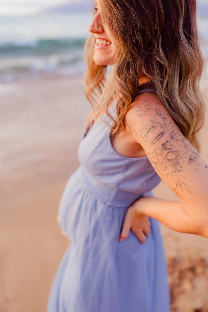 woman in light blue maternity gown with sleeve tattoo