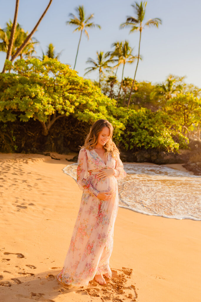 Maternity portrait of a 24 weeks pregnant woman wearing a Baltic Born Layla tulle maxi dress, photographed near the Andaz Resort in Wailea, Maui.