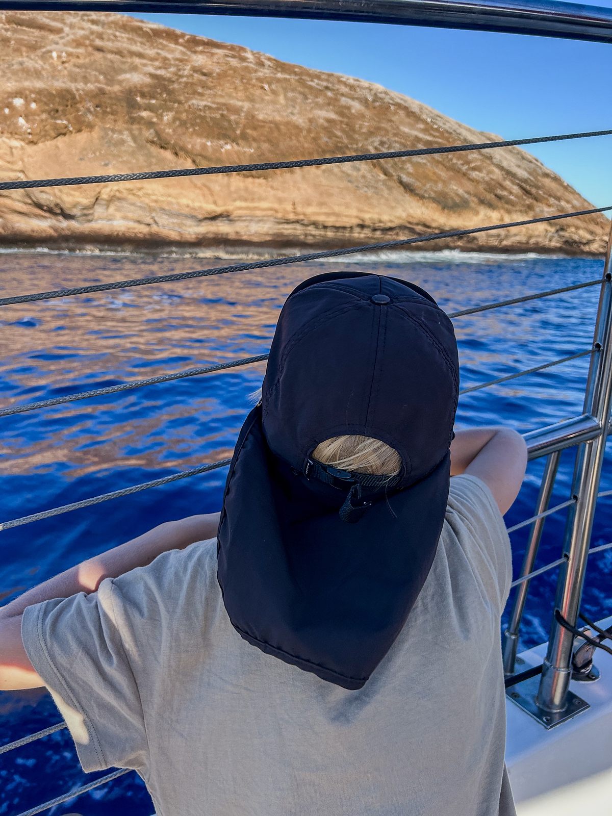boy chills out aboard a molokini sailboat with sail maui