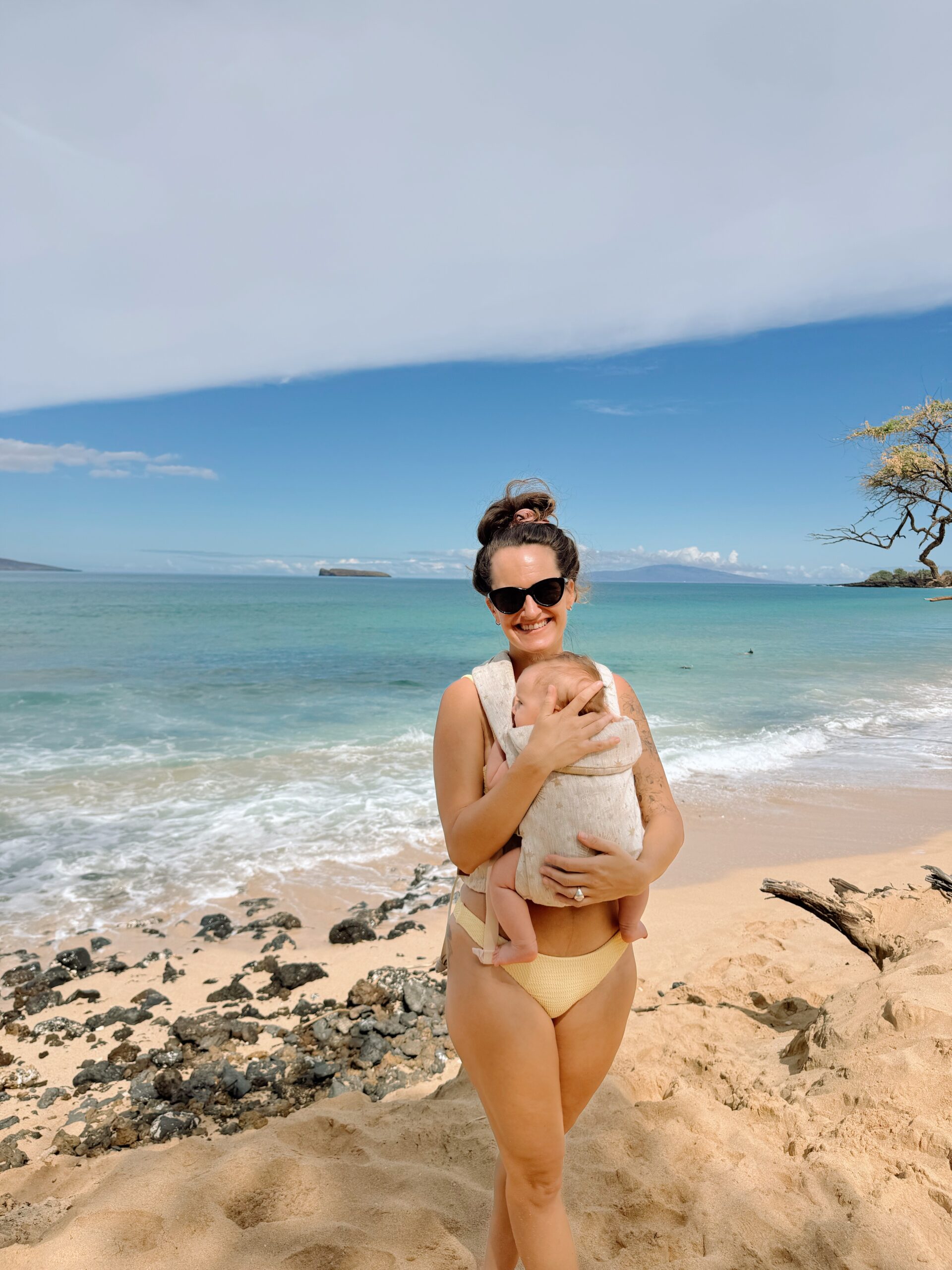 mom on maui holding new baby in wildbird aerial carrier