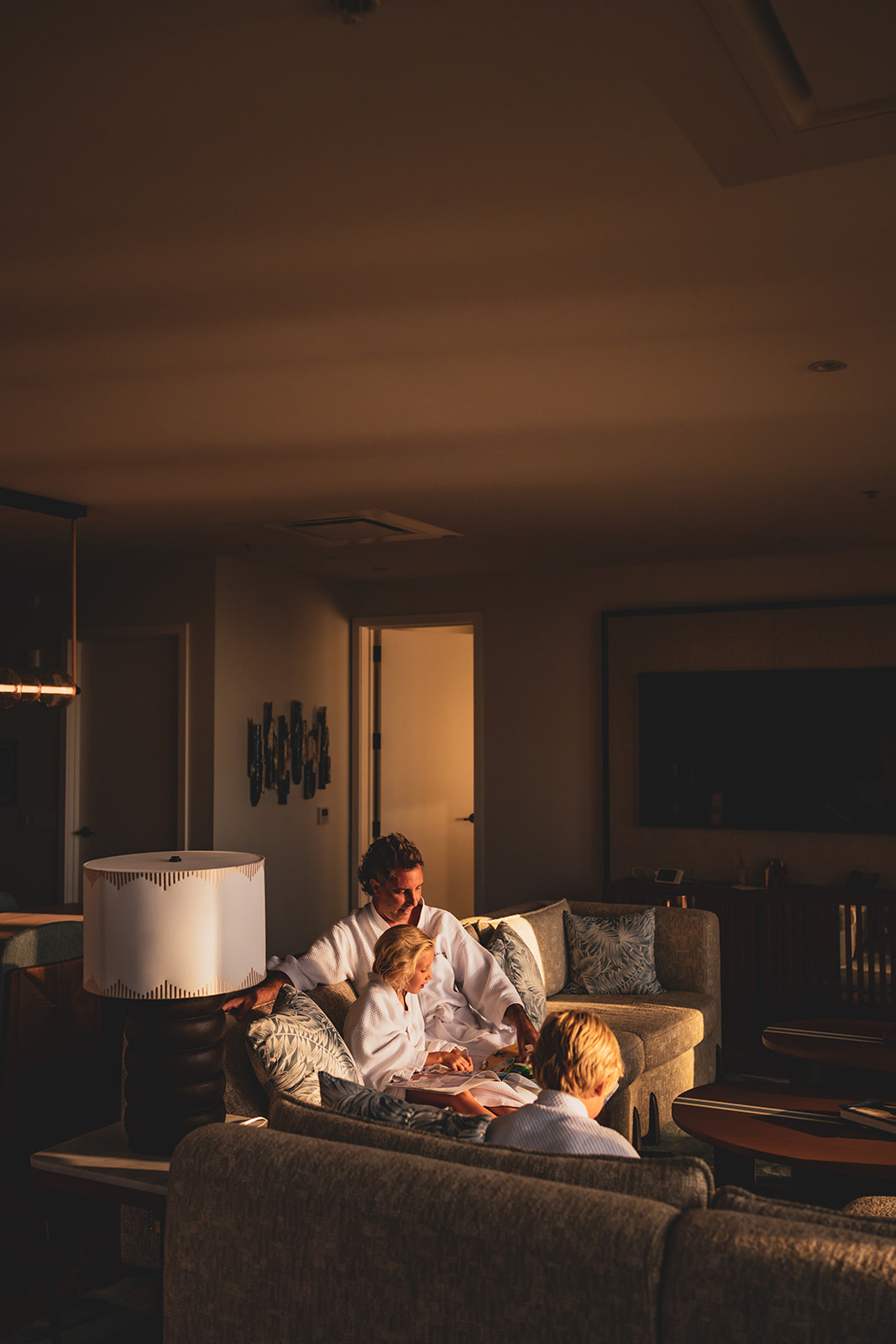 dad reads with kids on the couch