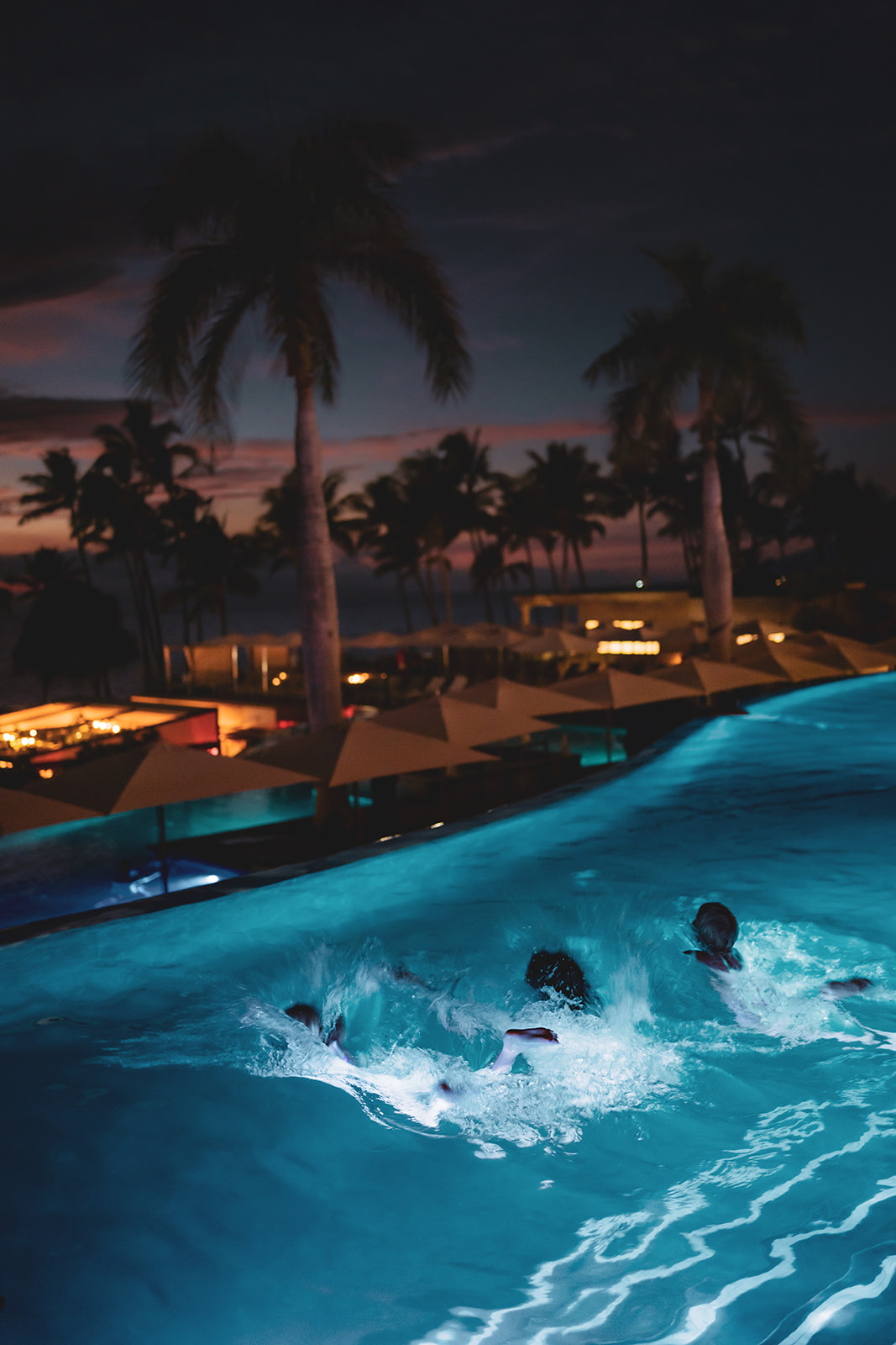 family swims at night at andaz resort pool